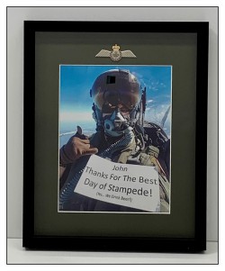 Black frame, grey mat with opening, photo, attaching pin to mat